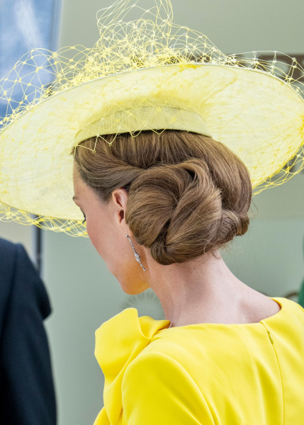 Kate Middleton's sideswept bun under a yellow hat